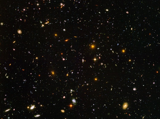 This view of nearly 10,000 galaxies is called the Hubble Ultra Deep Field. The snapshot includes galaxies of various ages, sizes, shapes, and colours. The smallest, reddest galaxies, about 100, may be among the most distant known, existing when the universe was just 800 million years old. The nearest galaxies - the larger, brighter, well-defined spirals and ellipticals - thrived about 1 billion years ago, when the cosmos was 13 billion years old. The image required 800 exposures taken over the course of 400 Hubble orbits around Earth. The total amount of exposure time was 11.3 days, taken between Sept. 24, 2003 and Jan. 16, 2004.